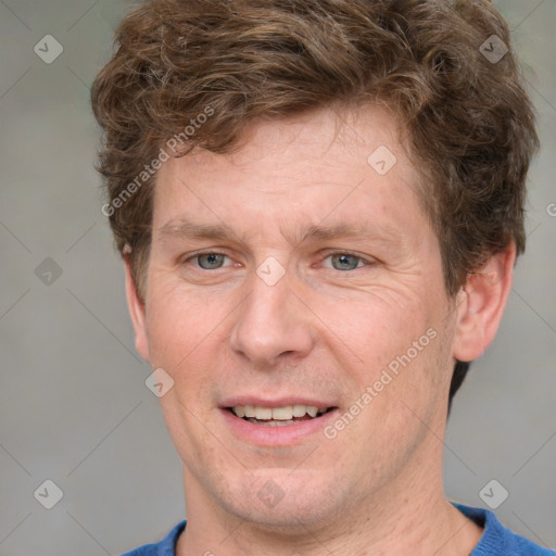 Joyful white adult male with short  brown hair and grey eyes