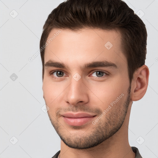 Joyful white young-adult male with short  brown hair and brown eyes