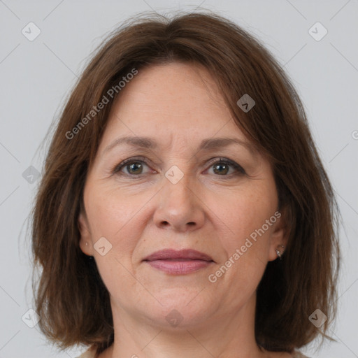 Joyful white adult female with medium  brown hair and brown eyes