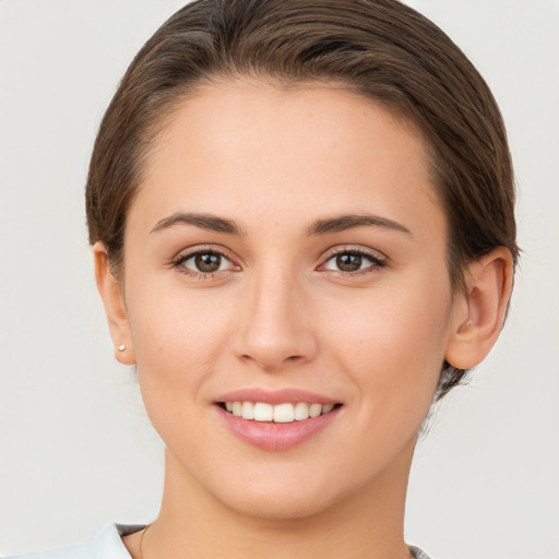 Joyful white young-adult female with short  brown hair and brown eyes