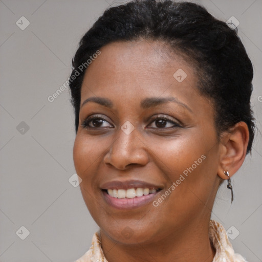 Joyful black young-adult female with medium  brown hair and brown eyes