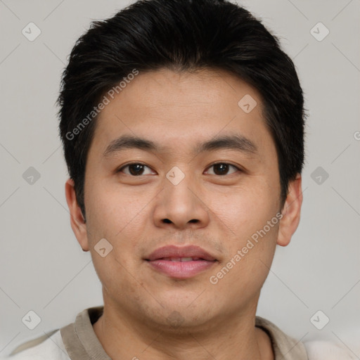 Joyful asian young-adult male with short  brown hair and brown eyes