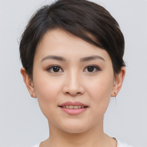 Joyful asian young-adult female with short  brown hair and brown eyes