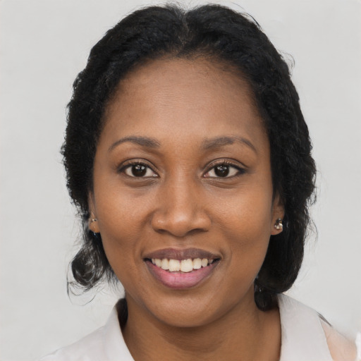 Joyful black young-adult female with medium  black hair and brown eyes