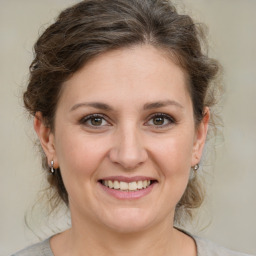 Joyful white young-adult female with medium  brown hair and grey eyes