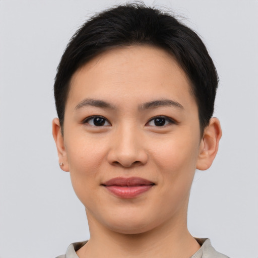 Joyful asian young-adult female with short  brown hair and brown eyes
