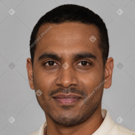 Joyful black young-adult male with short  black hair and brown eyes