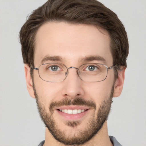 Joyful white young-adult male with short  brown hair and grey eyes