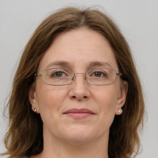 Joyful white adult female with medium  brown hair and green eyes