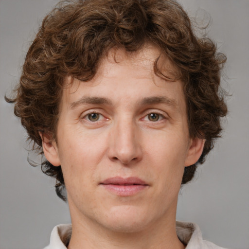 Joyful white young-adult male with medium  brown hair and brown eyes