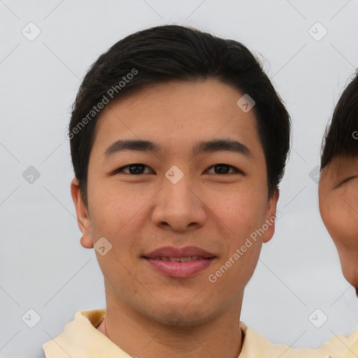 Joyful asian young-adult male with short  brown hair and brown eyes