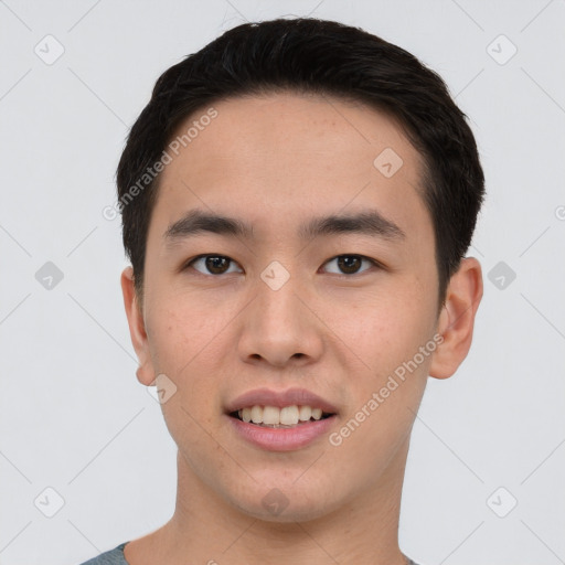 Joyful asian young-adult male with short  brown hair and brown eyes