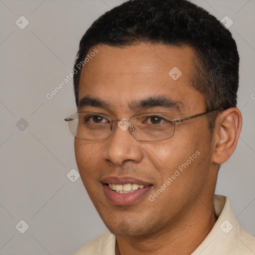 Joyful white young-adult male with short  black hair and brown eyes