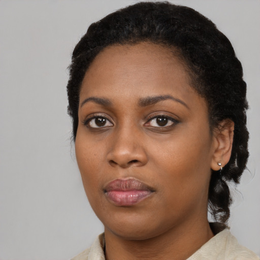 Joyful black young-adult female with medium  black hair and brown eyes
