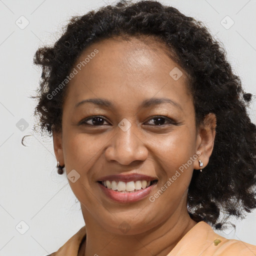 Joyful black adult female with medium  brown hair and brown eyes