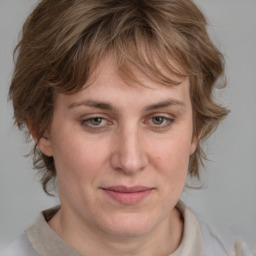 Joyful white adult female with medium  brown hair and blue eyes