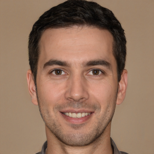 Joyful white young-adult male with short  brown hair and brown eyes