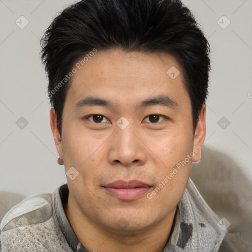 Joyful asian young-adult male with short  brown hair and brown eyes