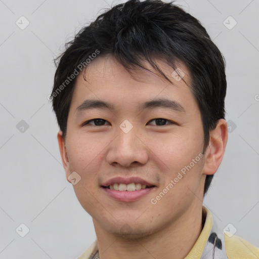 Joyful asian young-adult male with short  black hair and brown eyes