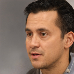 Neutral white adult male with short  black hair and brown eyes
