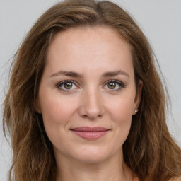 Joyful white young-adult female with long  brown hair and green eyes