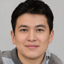 Joyful asian young-adult male with short  brown hair and brown eyes