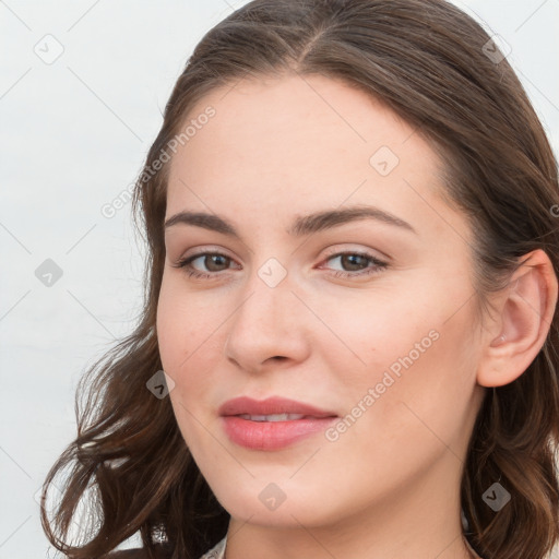 Joyful white young-adult female with long  brown hair and blue eyes