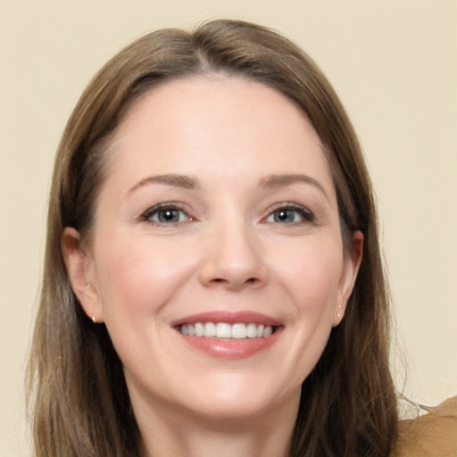 Joyful white adult female with long  brown hair and brown eyes