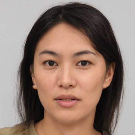 Joyful asian young-adult female with medium  brown hair and brown eyes