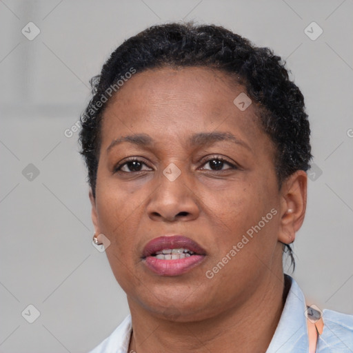 Joyful black adult female with short  brown hair and brown eyes