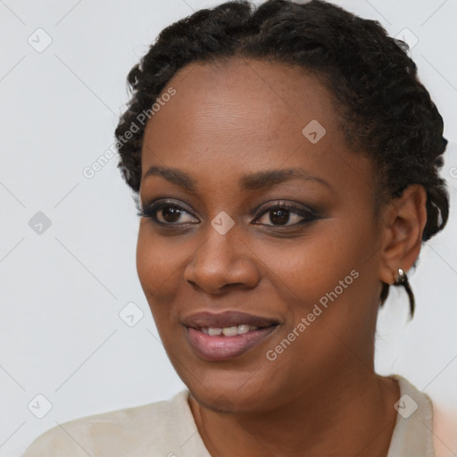 Joyful black young-adult female with short  black hair and brown eyes