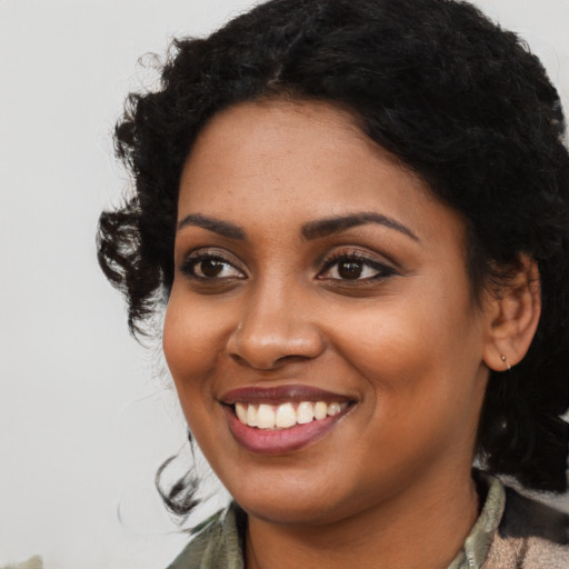Joyful latino young-adult female with medium  black hair and brown eyes