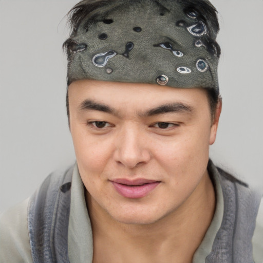 Joyful asian young-adult male with short  brown hair and brown eyes
