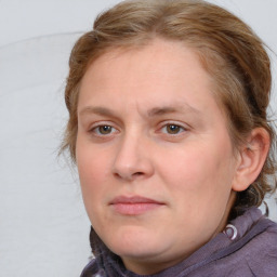 Joyful white young-adult female with medium  brown hair and blue eyes