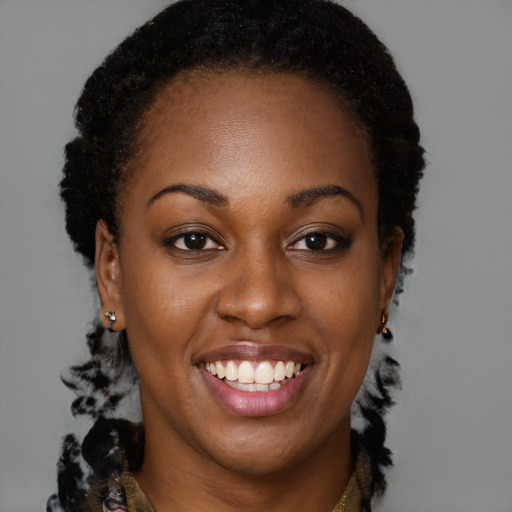 Joyful black young-adult female with long  brown hair and brown eyes