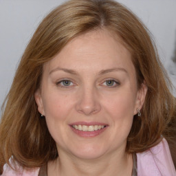 Joyful white adult female with medium  brown hair and brown eyes