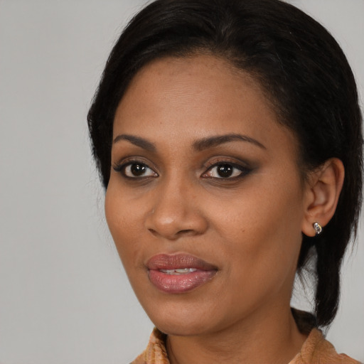 Joyful black young-adult female with medium  brown hair and brown eyes