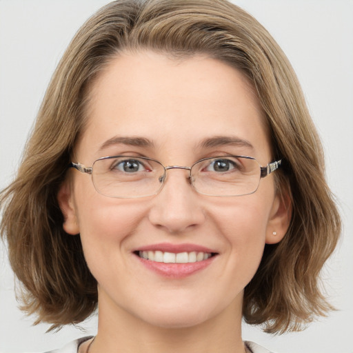 Joyful white adult female with medium  brown hair and blue eyes