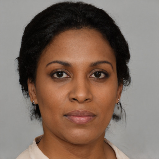 Joyful black young-adult female with medium  brown hair and brown eyes
