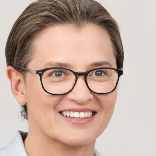 Joyful white adult female with medium  brown hair and blue eyes