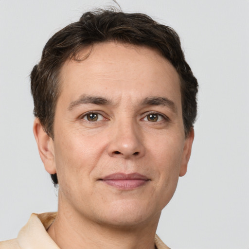 Joyful white adult male with short  brown hair and brown eyes