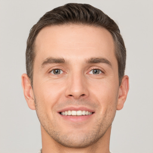 Joyful white young-adult male with short  brown hair and brown eyes