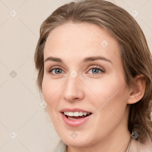 Joyful white young-adult female with medium  brown hair and blue eyes