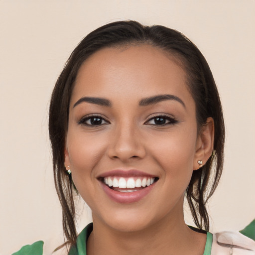 Joyful white young-adult female with long  brown hair and brown eyes