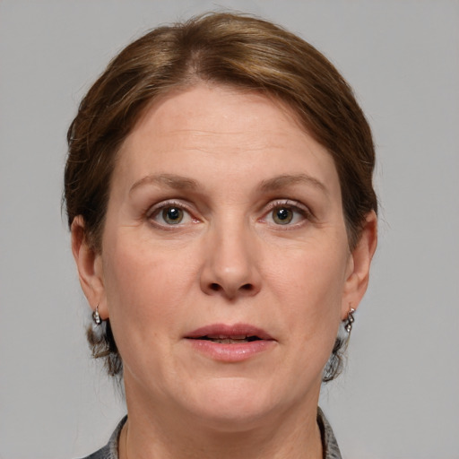 Joyful white adult female with medium  brown hair and grey eyes