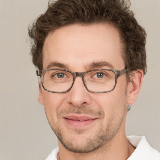 Joyful white adult male with short  brown hair and green eyes