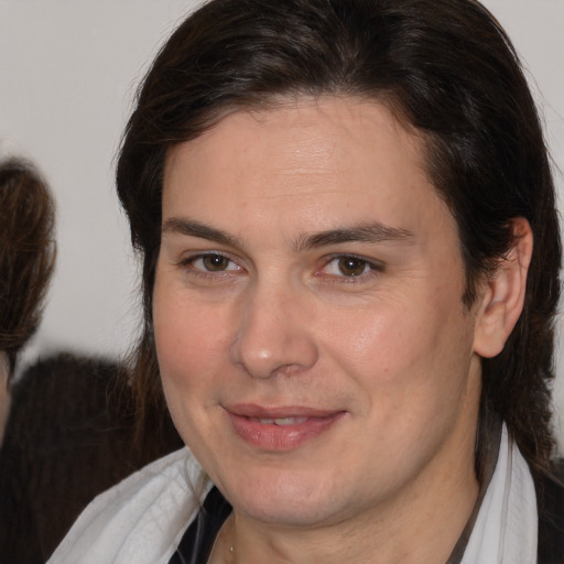 Joyful white adult male with medium  brown hair and brown eyes