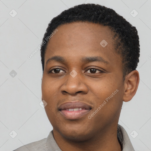 Joyful black young-adult male with short  black hair and brown eyes