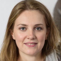 Joyful white young-adult female with long  brown hair and grey eyes