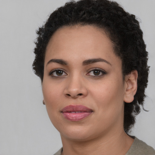 Joyful latino young-adult female with short  brown hair and brown eyes